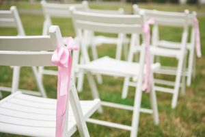 Pink-wedding-decorations-–-ideas-for-a-wonderful-wedding-party_wedding-with-white-chairs-and-light-pink-ribbons-attached